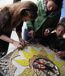 Participants making mosaic sunflower