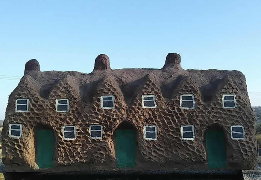 Model of a row of houses made from cob