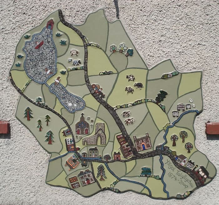 Map of Talley in mosaic and paint with Abbey, school, houses, lakes, farm animals and tractor